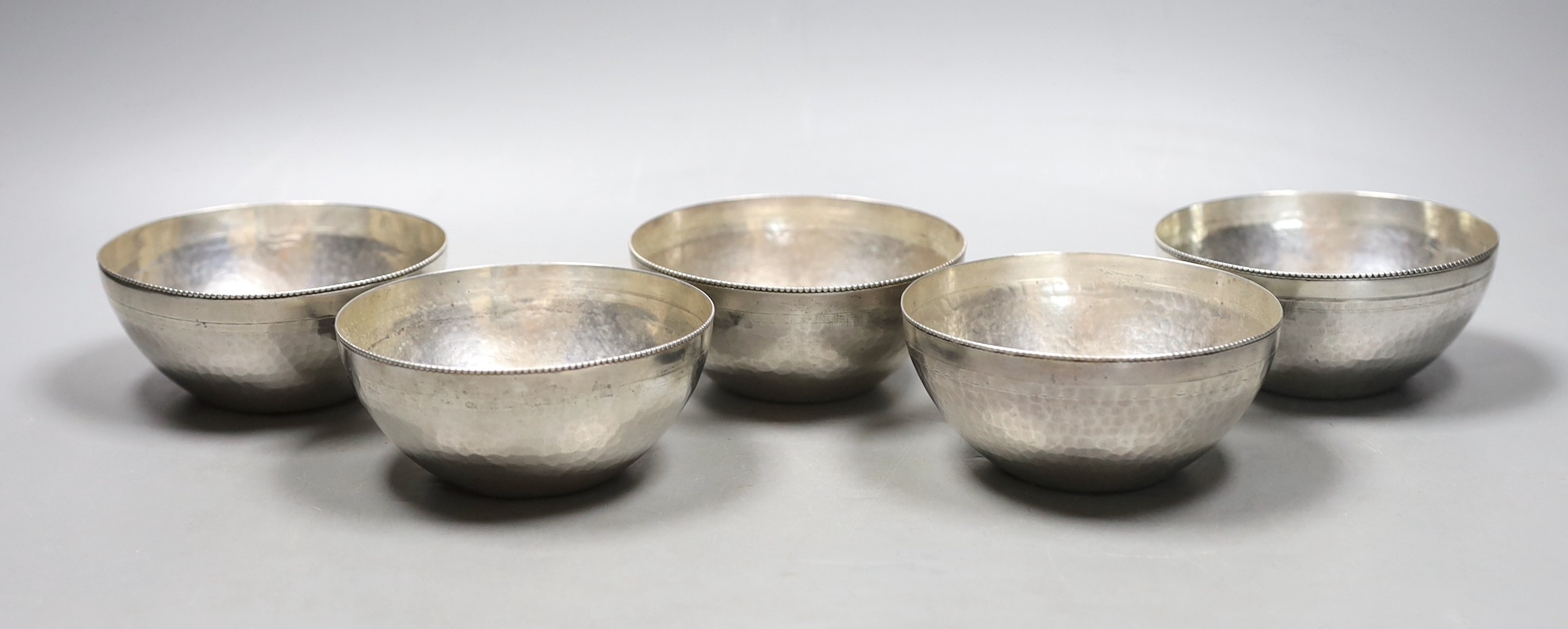 A set of five early to mid 20th century Egyptian planished white metal finger bowls, diameter 10.5cm, 22.5oz.